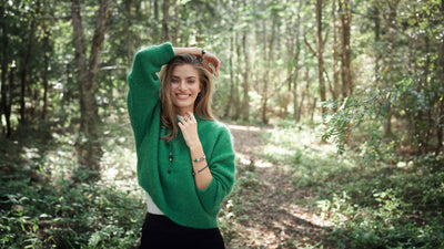 Model standing in a flower garden wearing Trollbeads jewellery